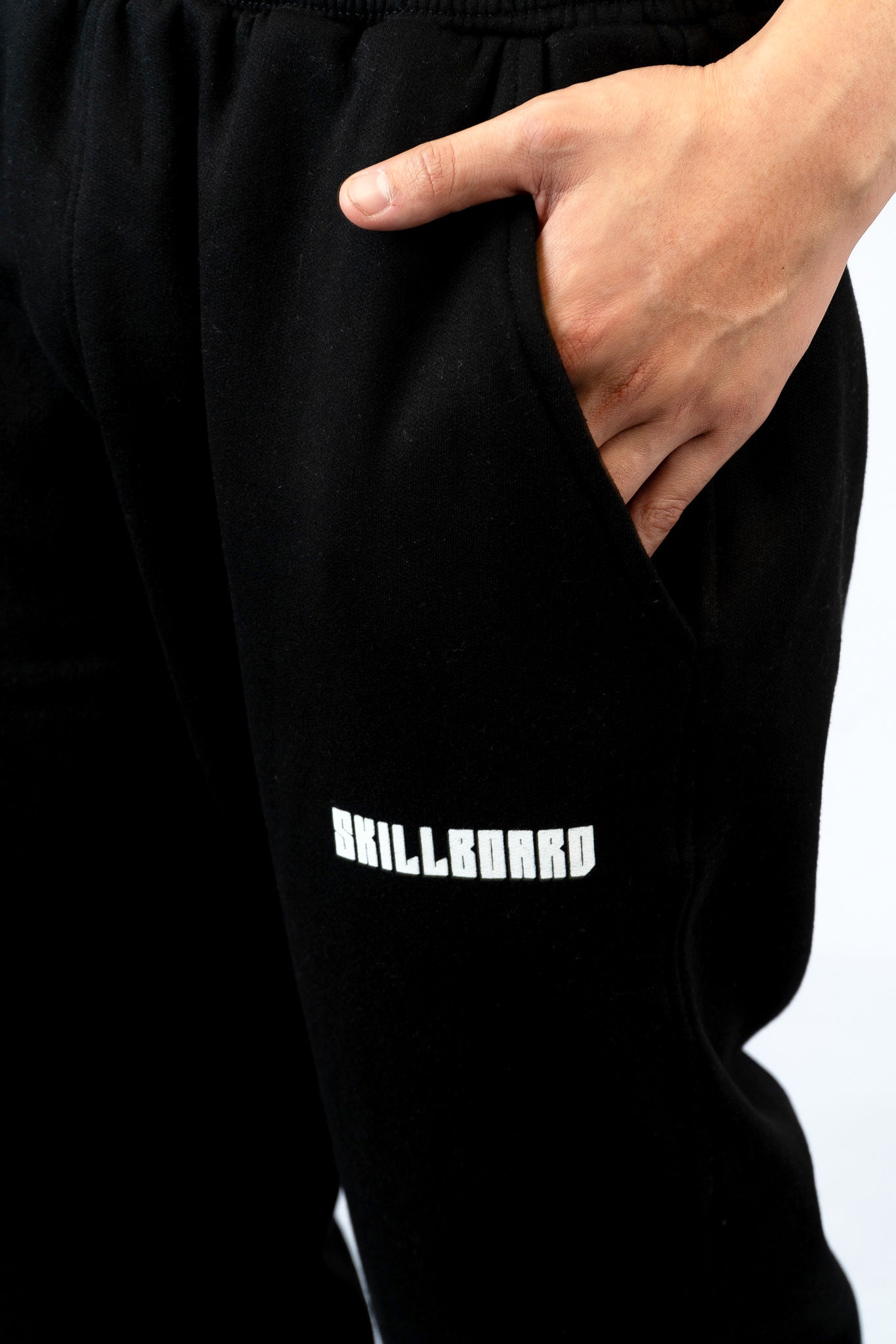 a person wearing a black sweatpants with a white logo