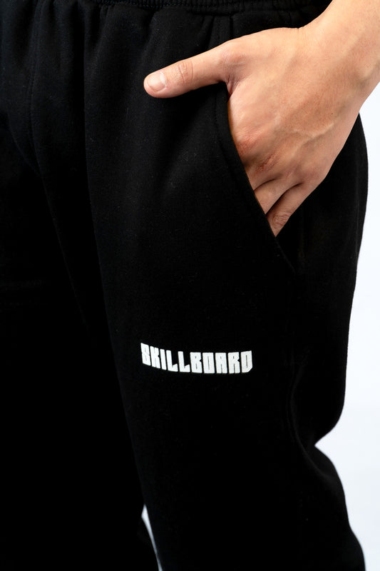 a person wearing a black sweatpants with a white logo